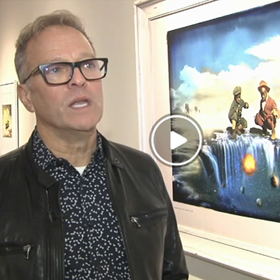 image from video segment on WFMZ about Denis Aumiller's Somnia Terra 1 art exhibit, showing Denis speaking in front of a photograph from the show